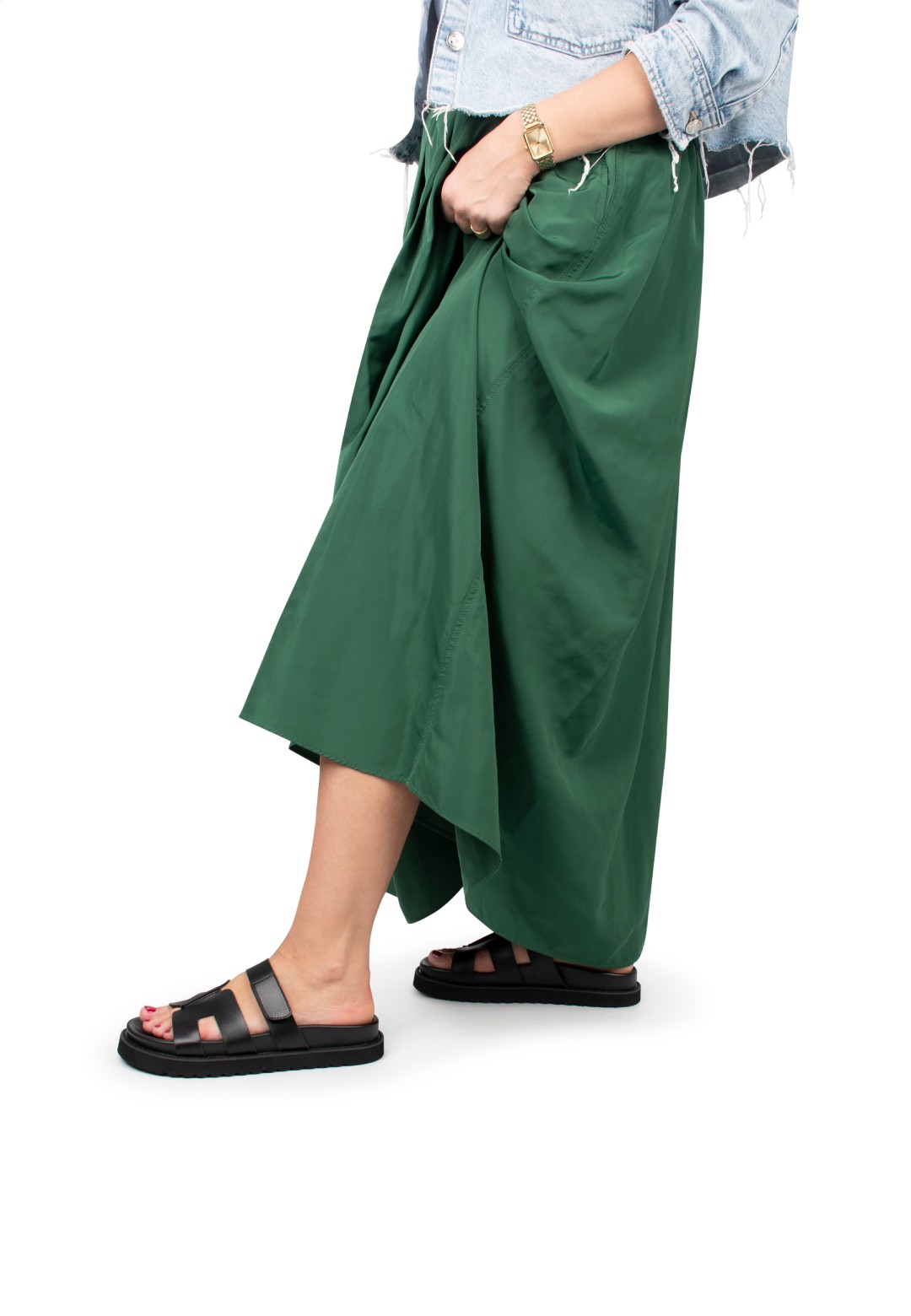 Model wearing a green skirt with black Scottie sandals by Posh by Poelman.