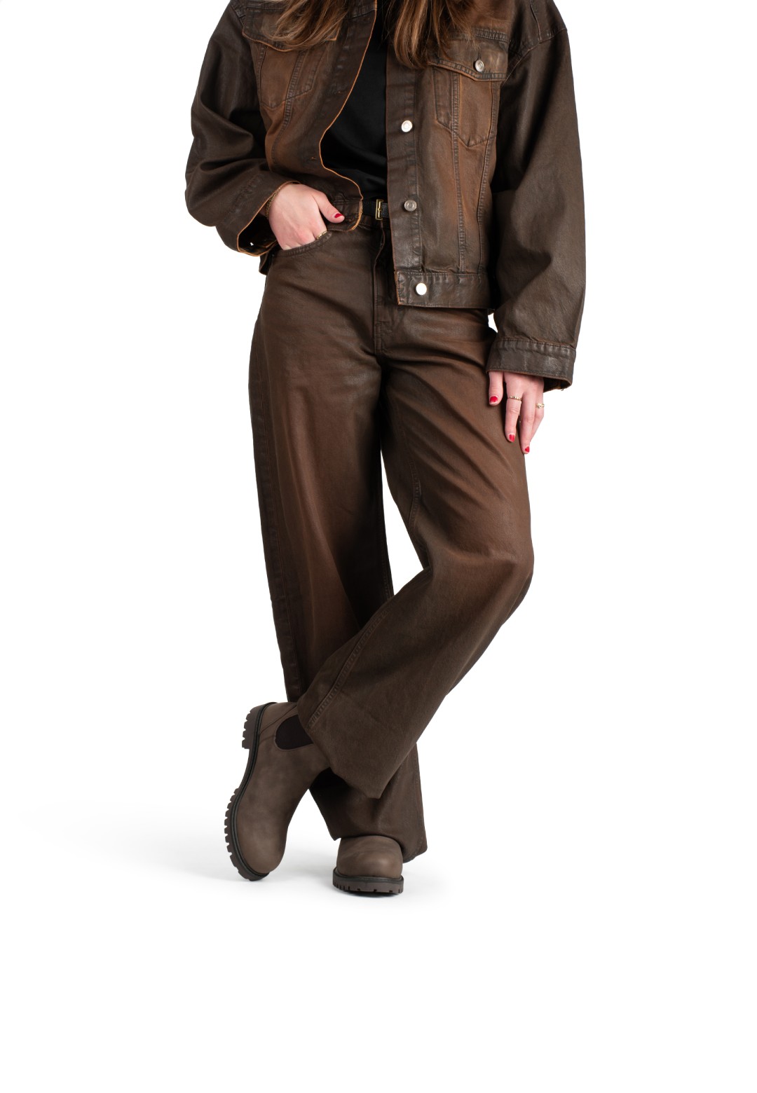 Model wearing RAYA boots with casual brown outfit, side view