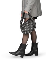 Model wearing black Febe ankle boots by PS Poelman paired with a skirt and handbag, elegant look.