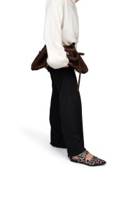 Model tilt voet op met AVA slingbacks in panterprint