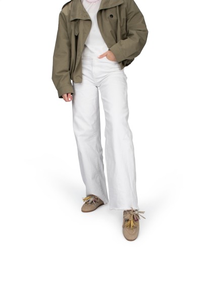 Model wearing white trousers with beige Vita loafers by PS Poelman.