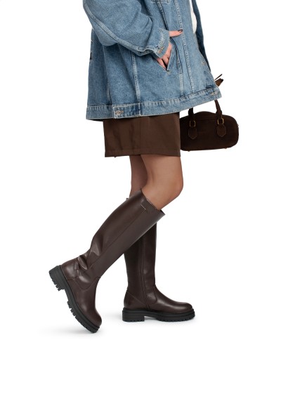 Model draagt FAY laarzen – hoge imitatie leren laarzen gestyled met denim jas en rok