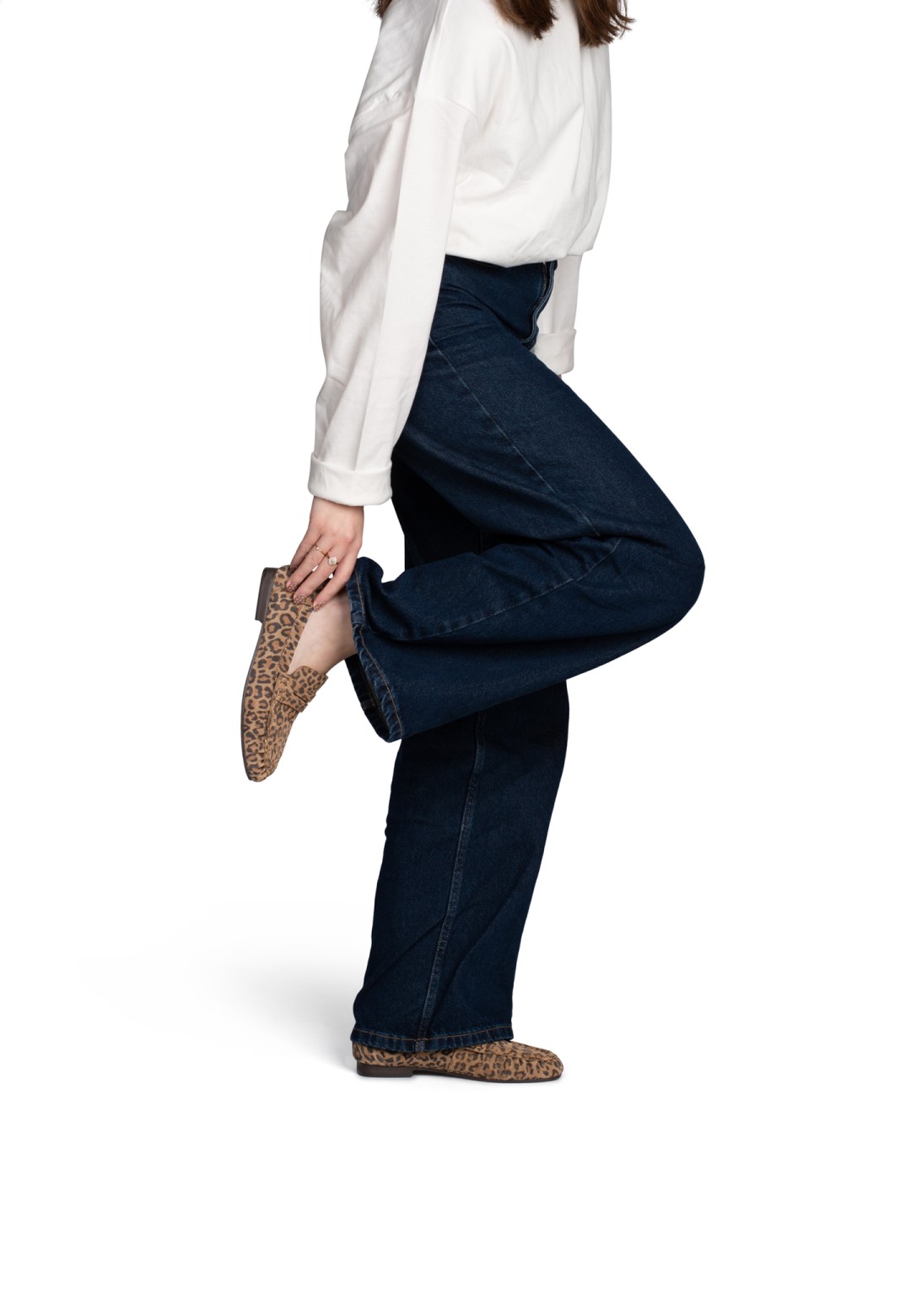 Side view of the Sammy loafers with leopard print worn with blue flared jeans