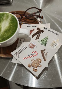 POELMAN.Brands sticker sheets on a table next to a matcha latte and glasses