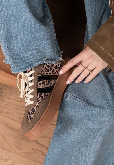 Close-up of LILLY sneaker worn by model, showing leopard print and laces