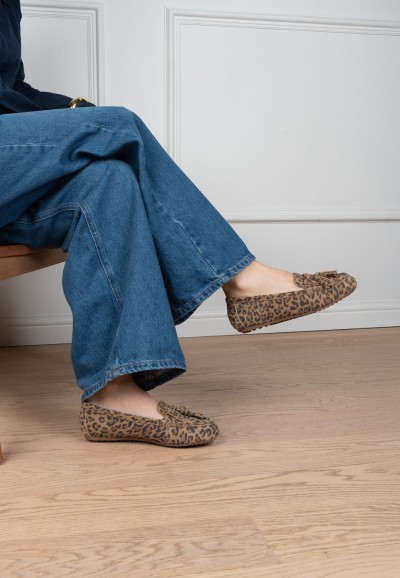 TAYA leopard print loafers styled with flared jeans – seated pose