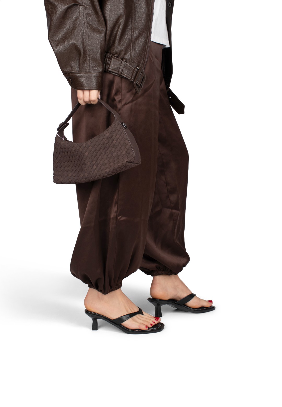 Model wearing POSH by Poelman Lucy black heels with brown outfit – side view