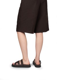 SCOTTIE sandals worn with brown shorts – back view