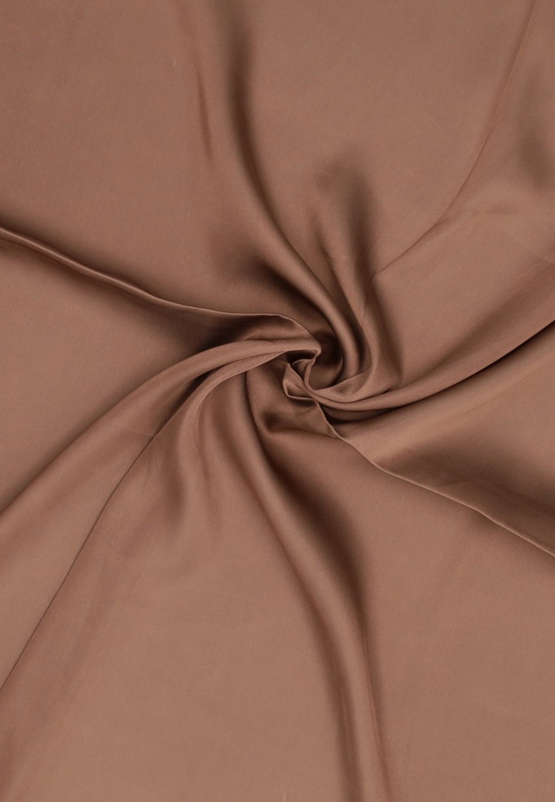 Close-up of brown fabric with twisted folds