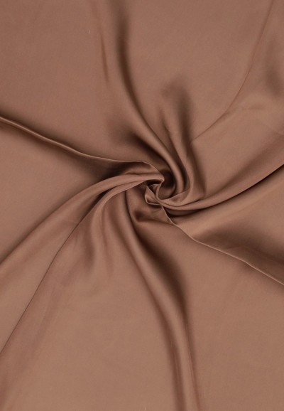 Close-up of brown fabric with twisted folds
