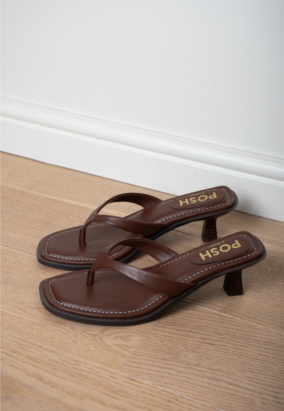POSH by Poelman Lucy brown heels – detail on wooden floor
