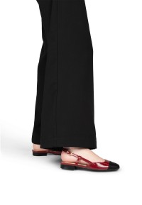 Haboob Bisou red slingback flats worn with black trousers, side view