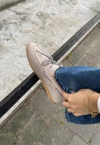 Model wearing PS Poelman Callie beige loafers with jeans – close-up