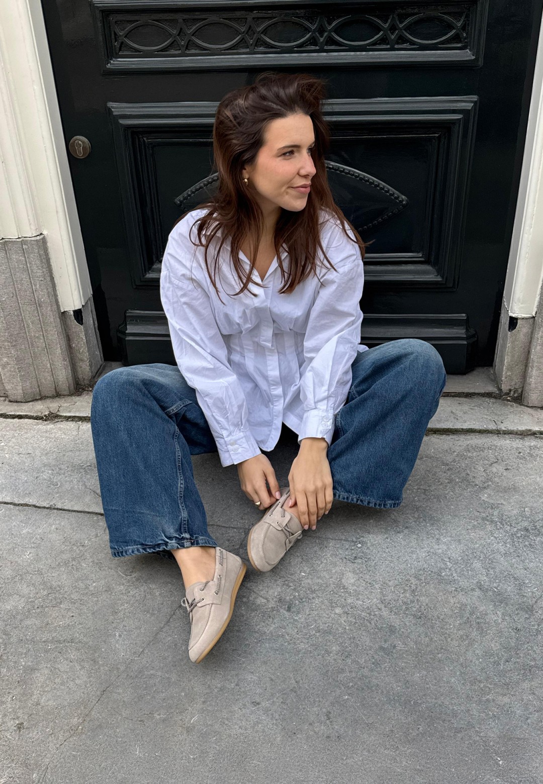 Model trägt PS Poelman Callie beige Loafer sitzend draußen – Lifestyle