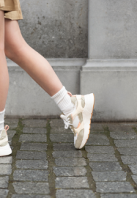 The model is wearing Caro sneakers by POSH by Poelman.