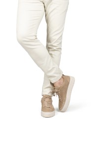 Model wearing PS Poelman Ivar beige sneakers with light trousers – side view