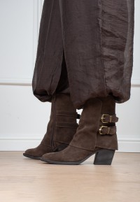 Model wearing Poelman Rosa brown boots with buckle details – side view