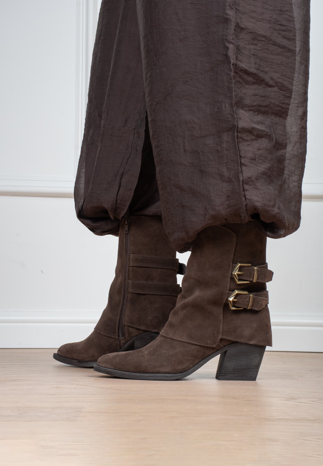 Model wearing Poelman Rosa brown boots with buckle details – side view