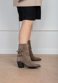 Model wearing Poelman Rosa taupe boots with buckle details – side view