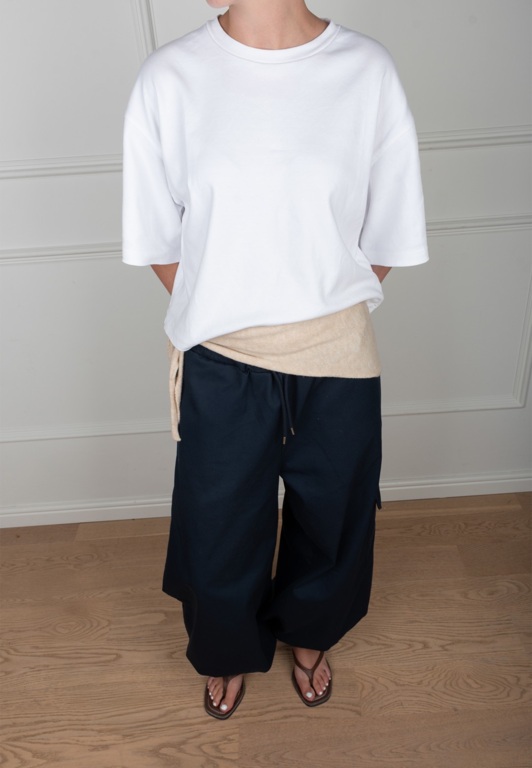 Poelman cream-coloured scarf styled around the waist with women’s outfit