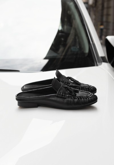 POSH by Poelman LOTTIE black loafers with chunky sole on a white car