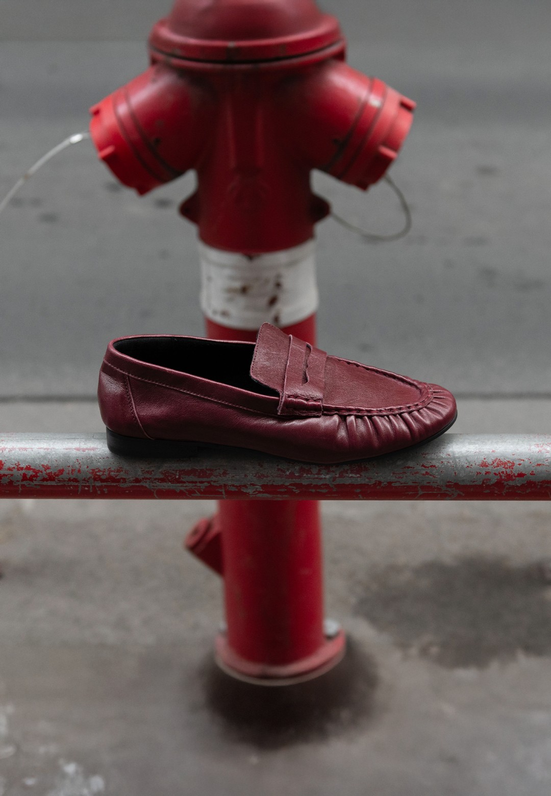 Side view of Poelman SAMMY burgundy leather loafer with penny detail